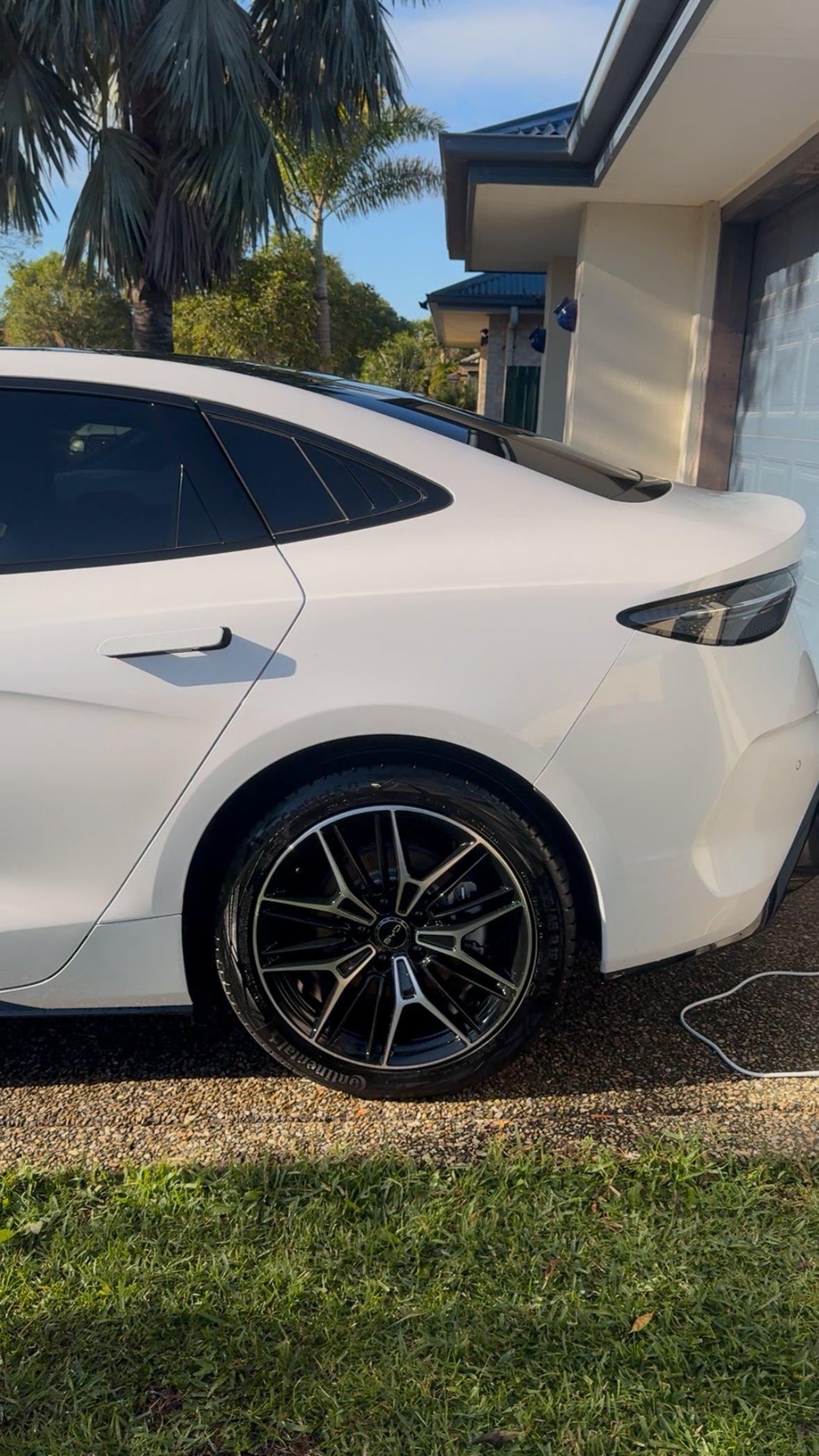 White BYD sedan polished to a mirror gloss finish