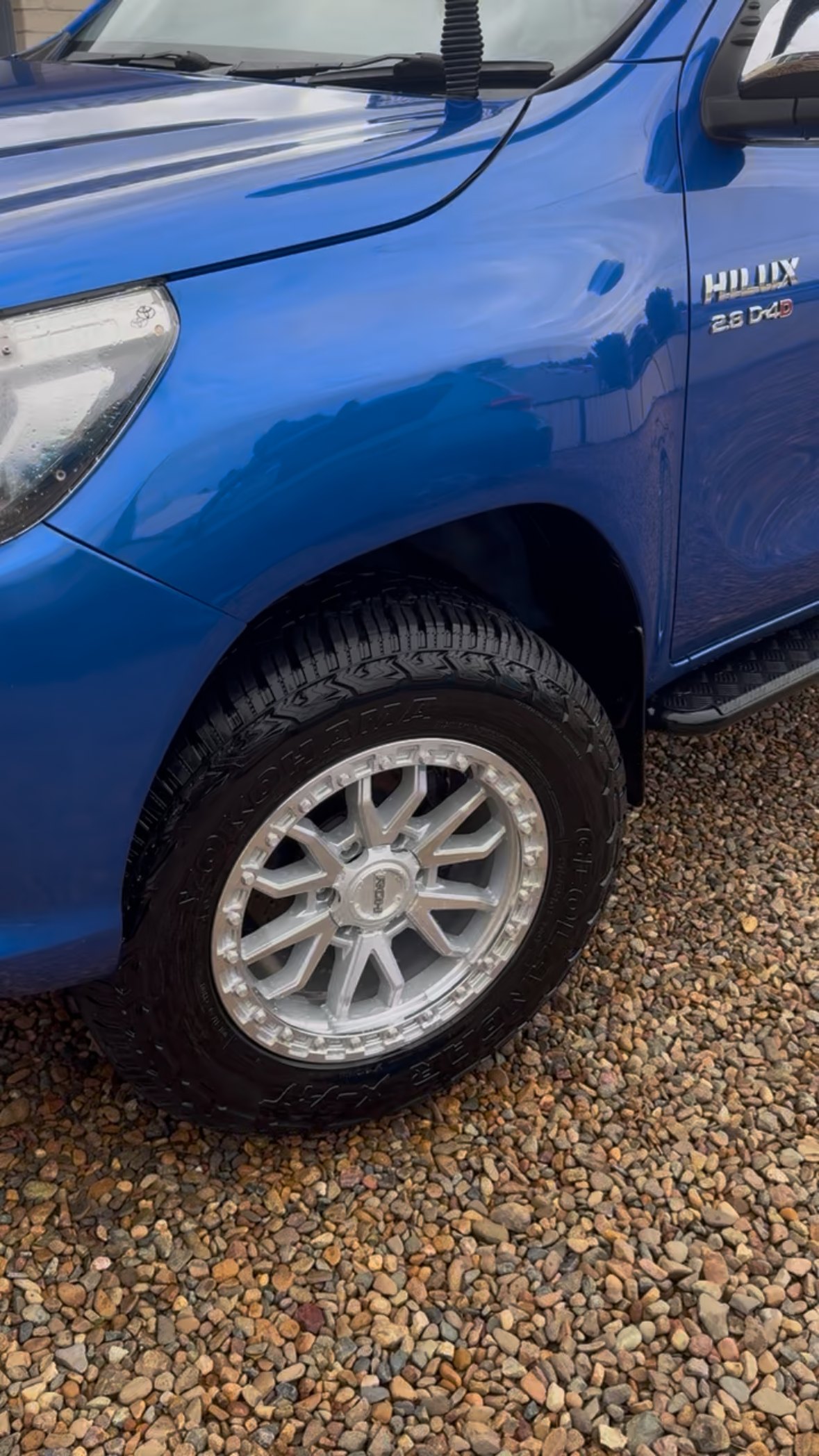 Blue Toyota Hilux front guard and polished alloy wheel after detailing