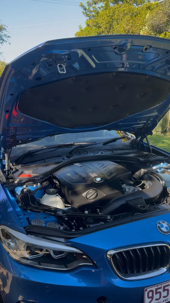 Blue BMW 2 Series engine bay cleaned and dressed