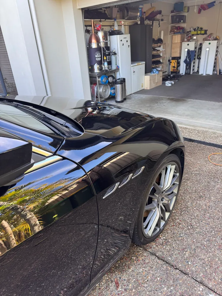 Mobile detailing setup beside a freshly washed car